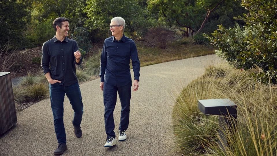 John Ternus and Tim Cook walking together at Apple Park