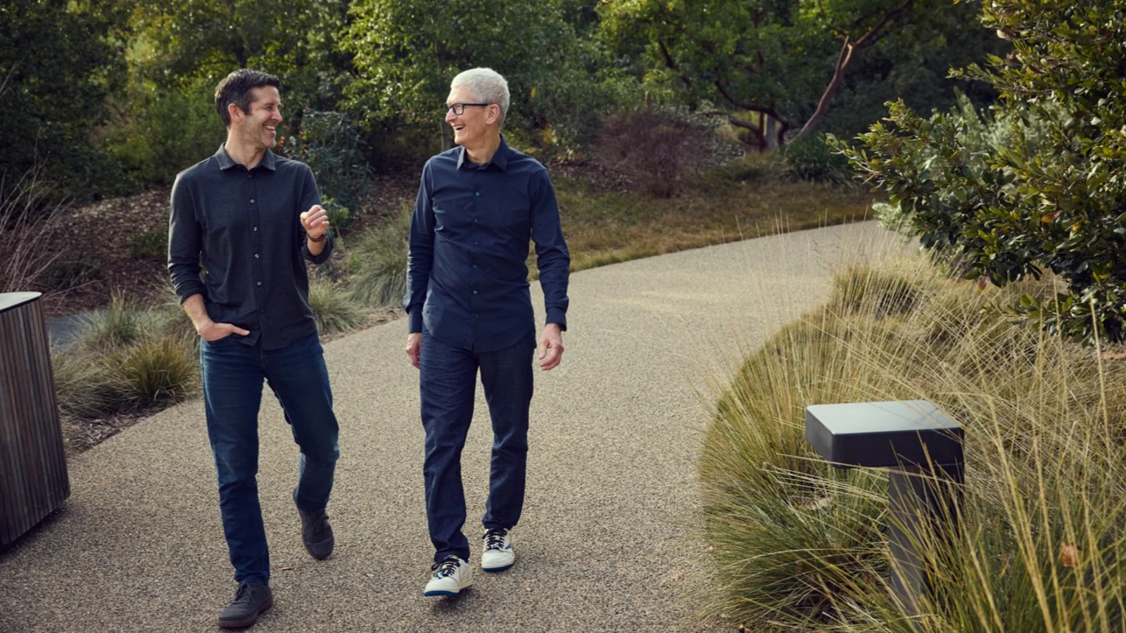 John Ternus and Tim Cook walking together at Apple Park